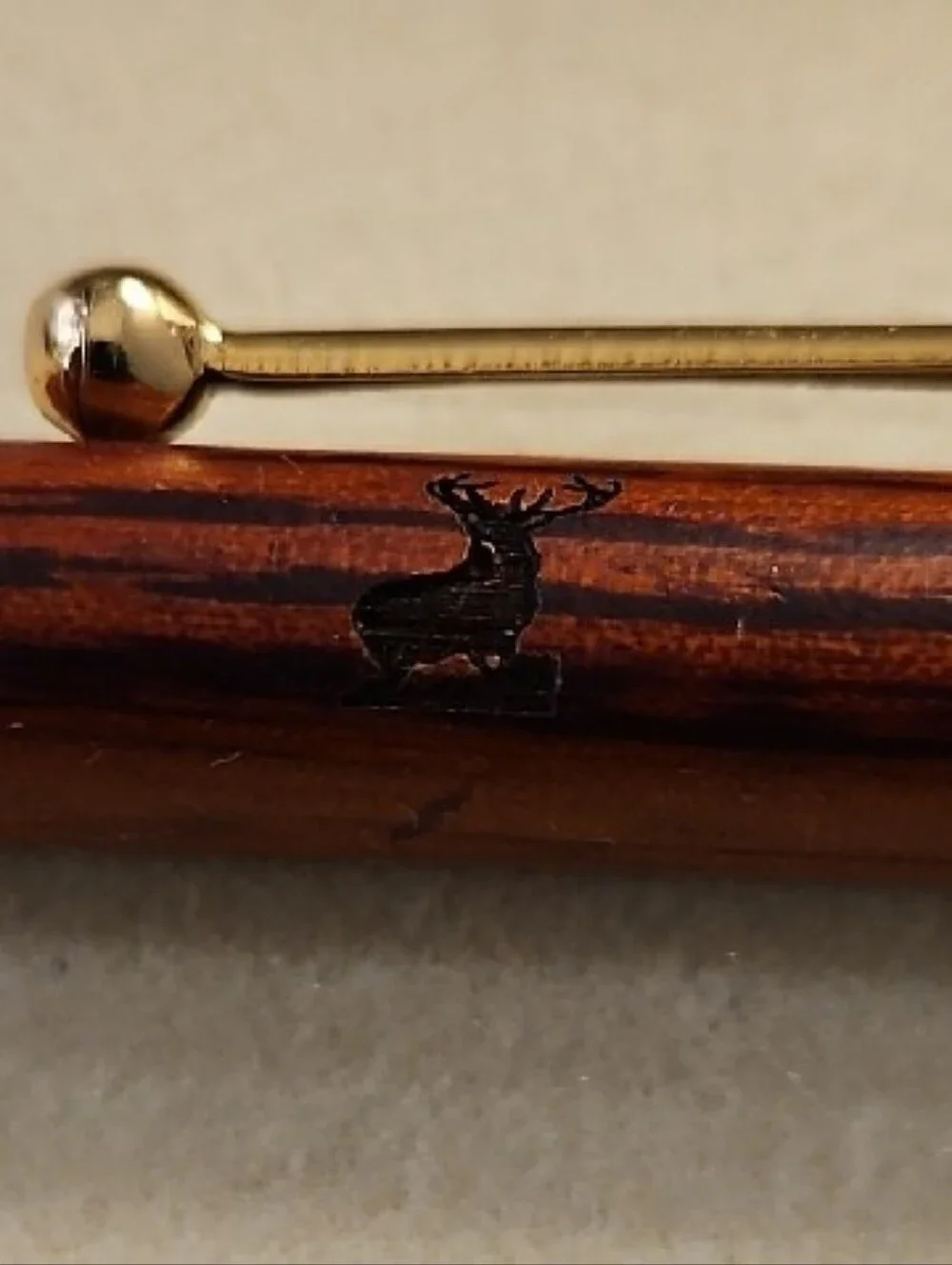 WOOD GRAIN TWIST SLIM LINE STYLE BALLPOINT PEN WITH GOLD TRIM AND A BUCK ON IT